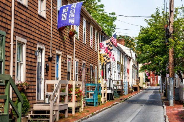 Street lined with houses flying colorful flags