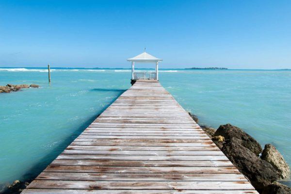 Pier sticking out into the blue ocean