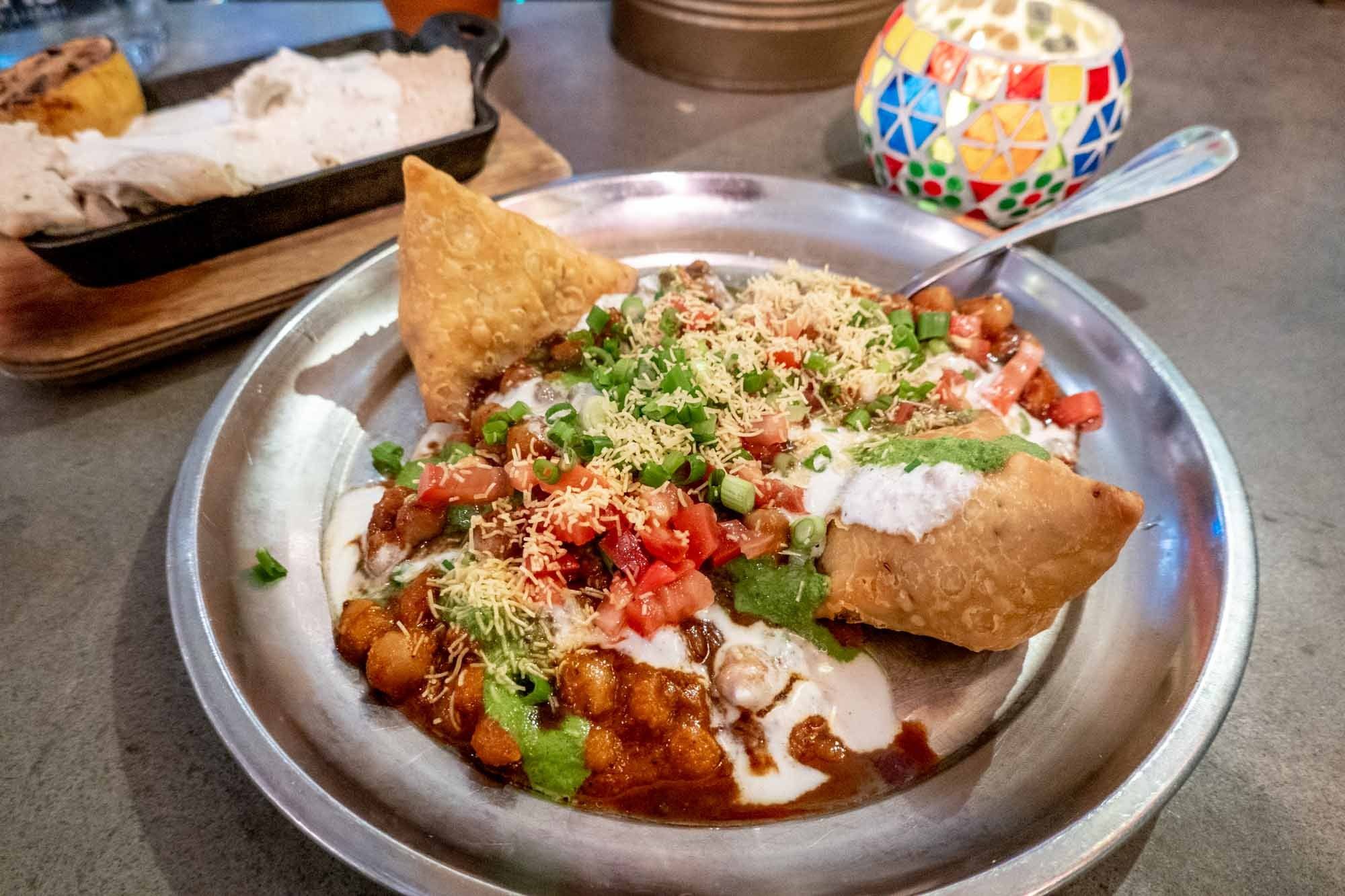 Samoas and colorful vegetable curry on a plate