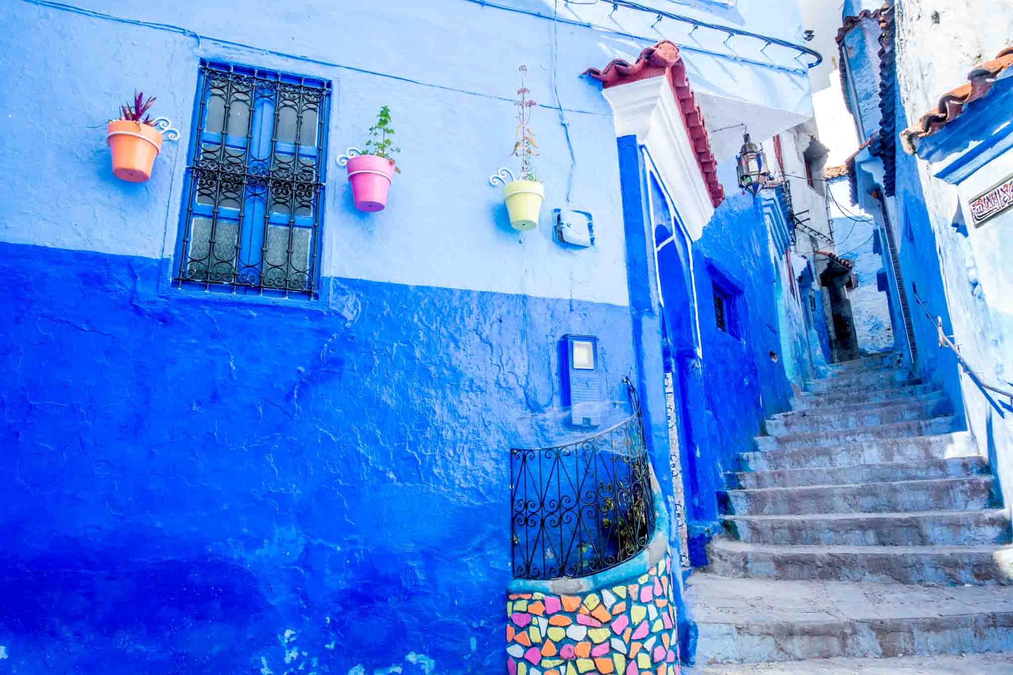 Blue wall accented with tile next to a stairway