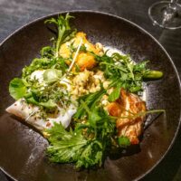 Fish entree in black bowl at Reykjavik restaurant