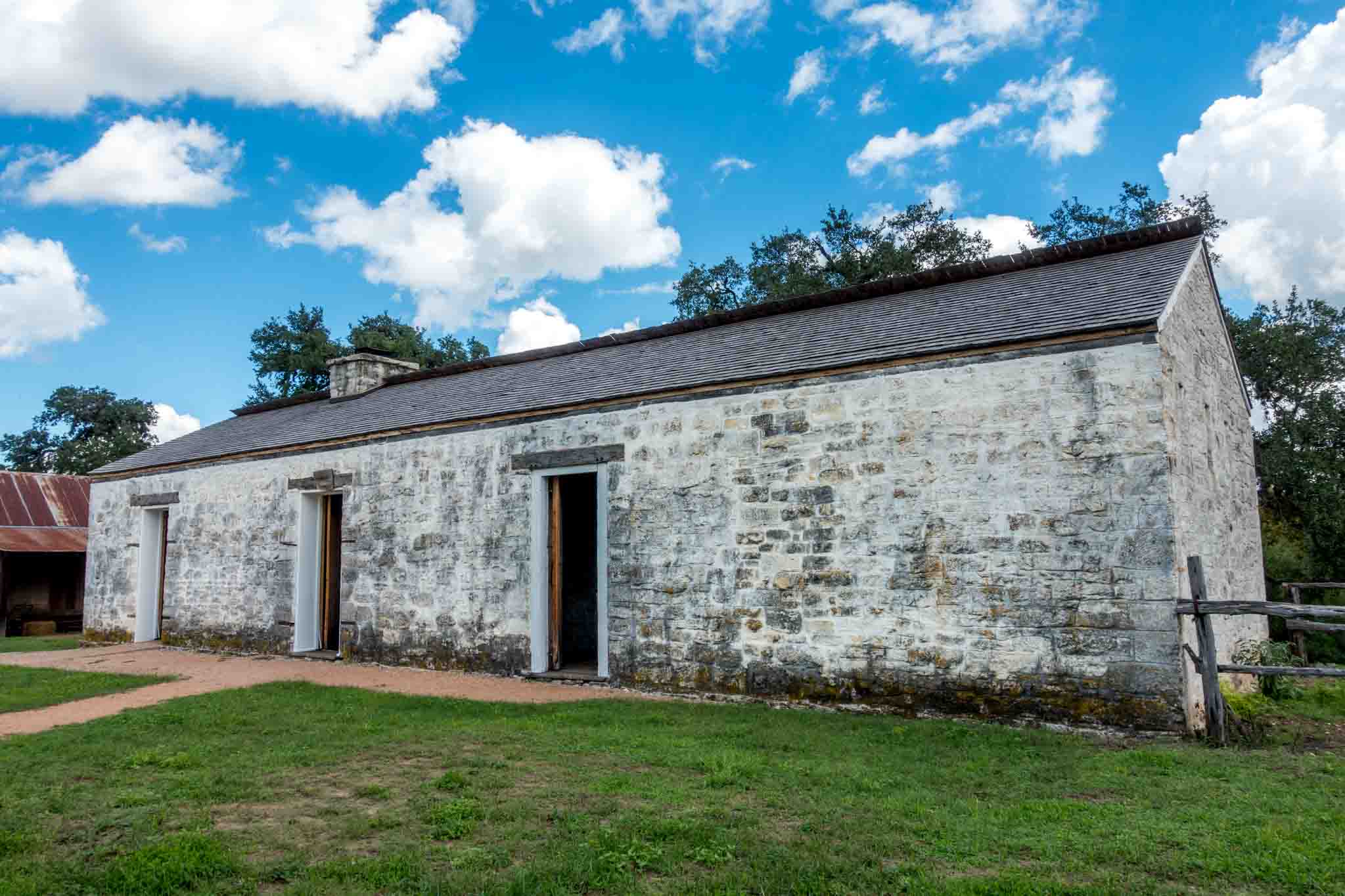 Stone building with three doors.