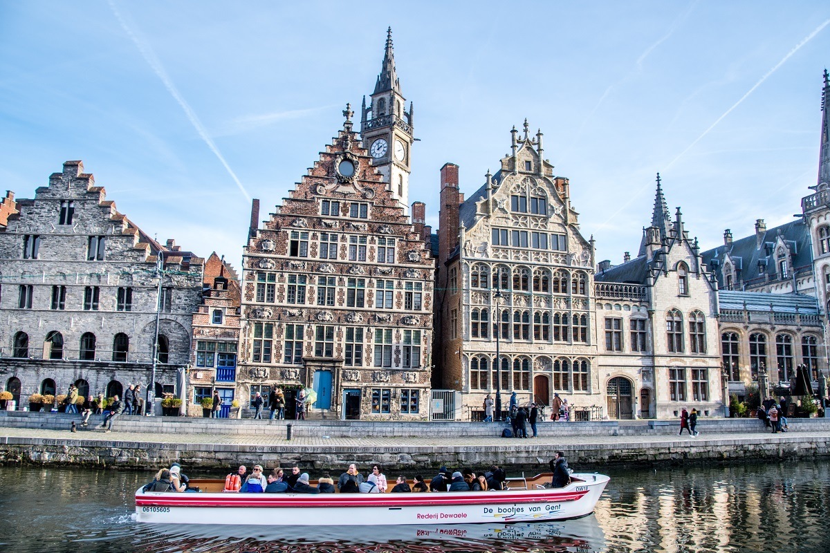 Boat cruising on the river in Ghent Belgium by historic buildings