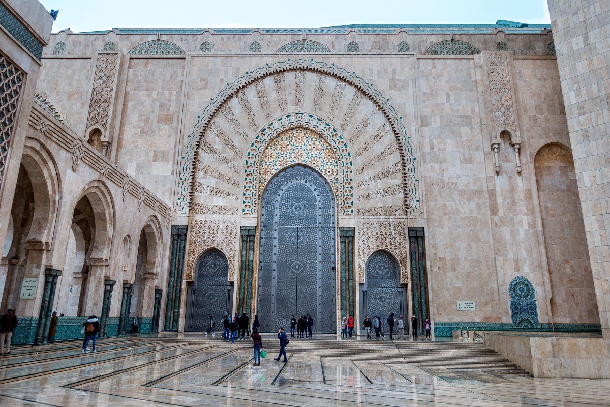 Visitors outside a large, decorative door