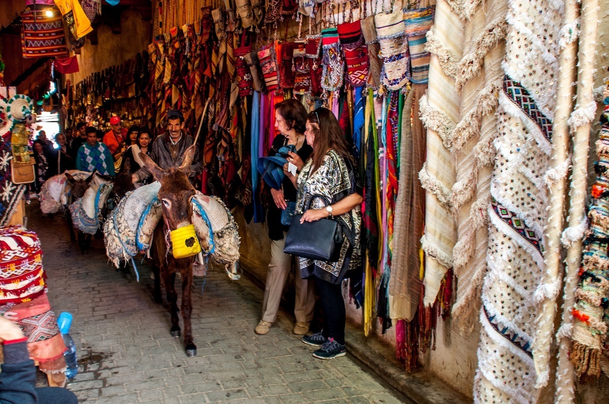 Donkey carrying goods through a market