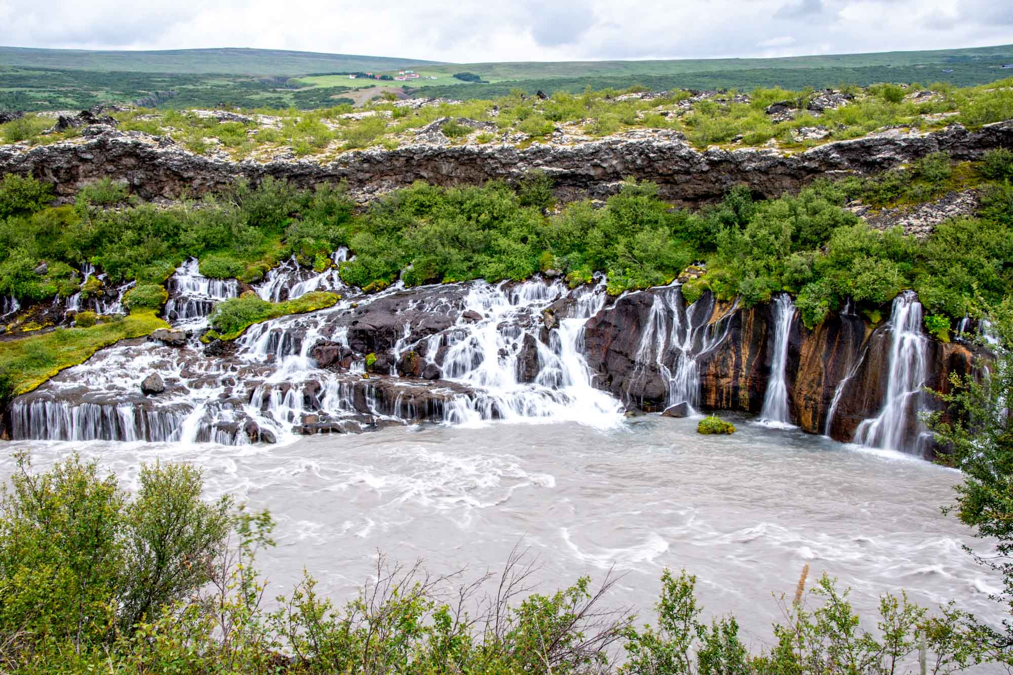 Numerous waterfalls pouring over a cliff