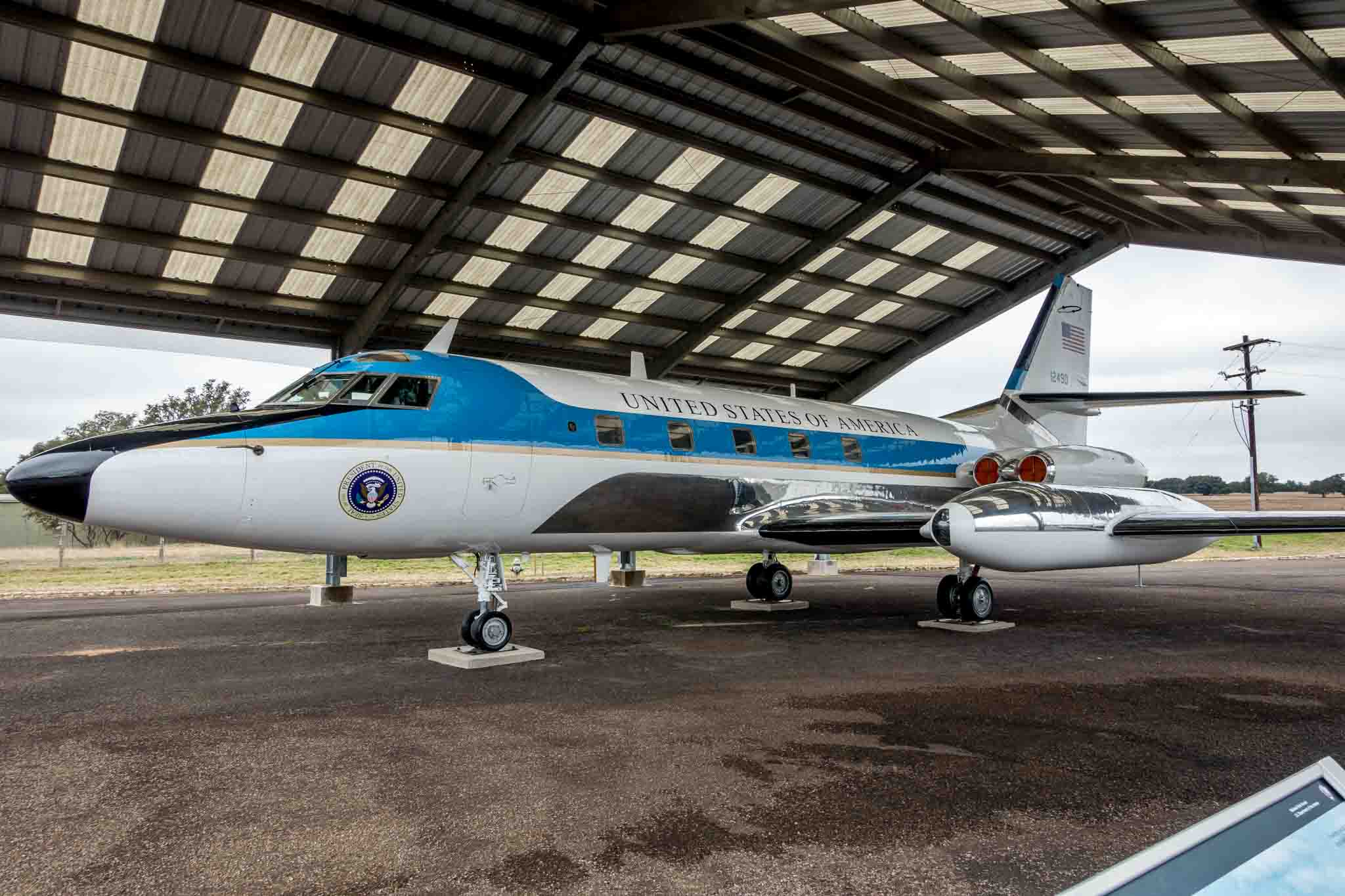 Plane labeled "United States of America" under a hangar.