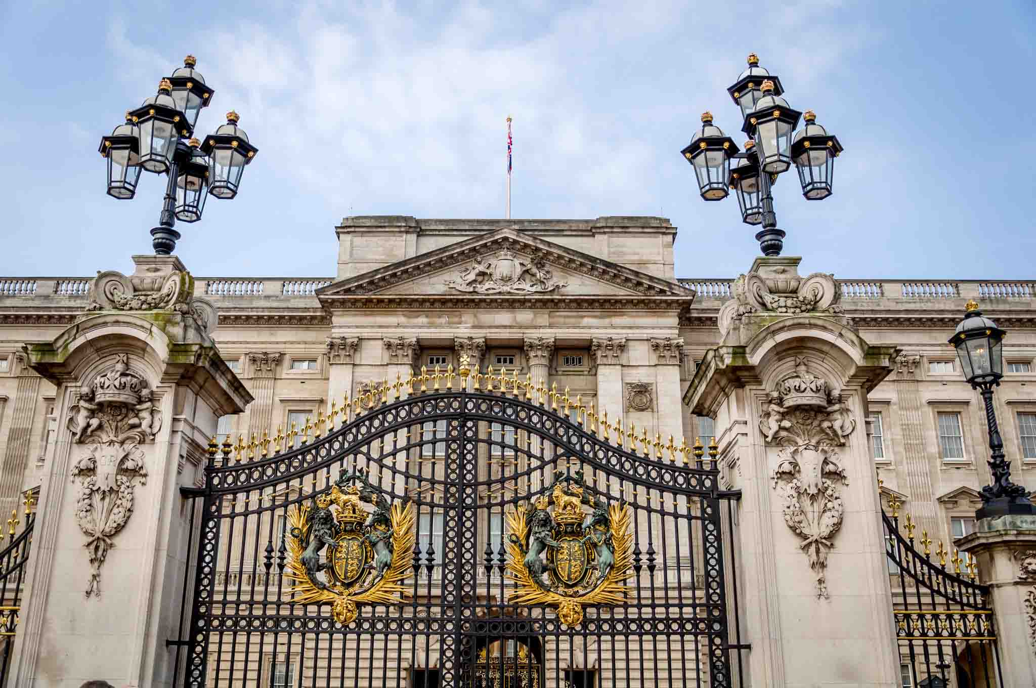 Buckingham Palace and its gates with gold crests seen on a long Heathrow Layover