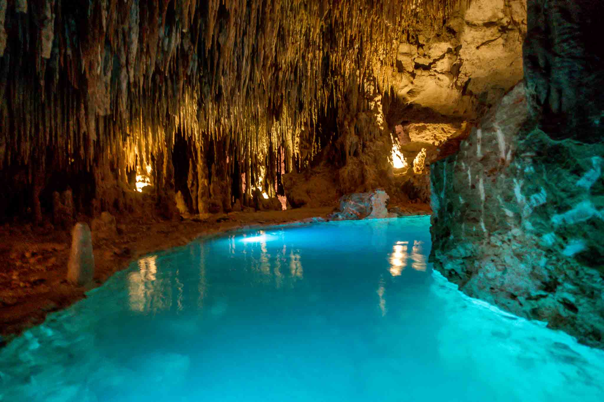 Underground river illuminated blue at Xplor adventure park in Playa del Carmen, Mexico