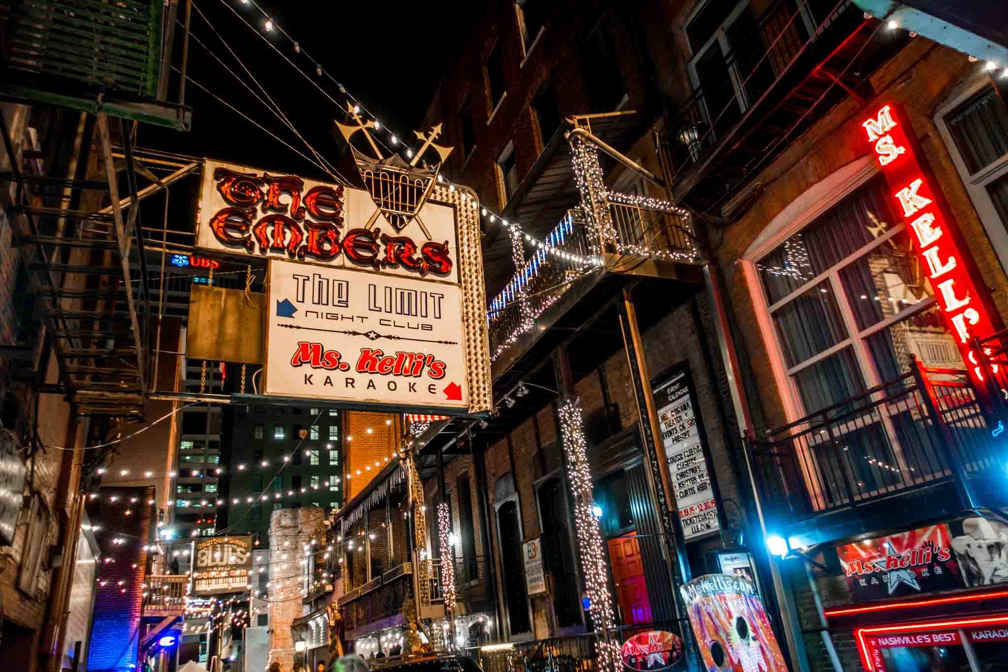 Signs advertising clubs and restaurants in Printers Alley.