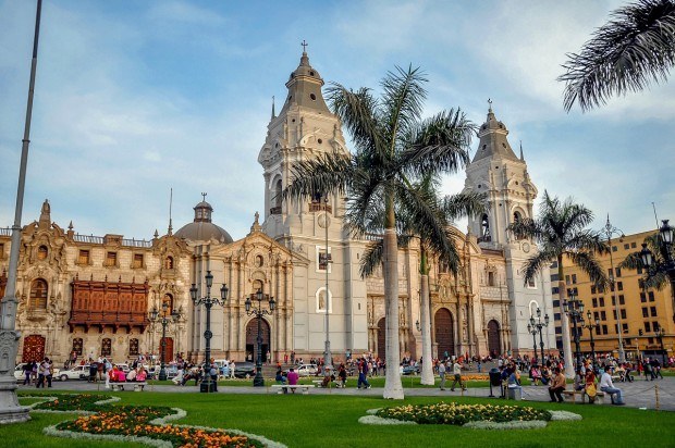 Church and palm trees in a busy city square
