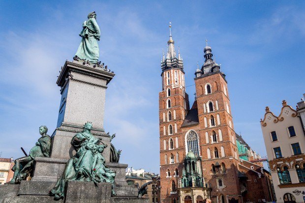 Statue beside a church in a city square