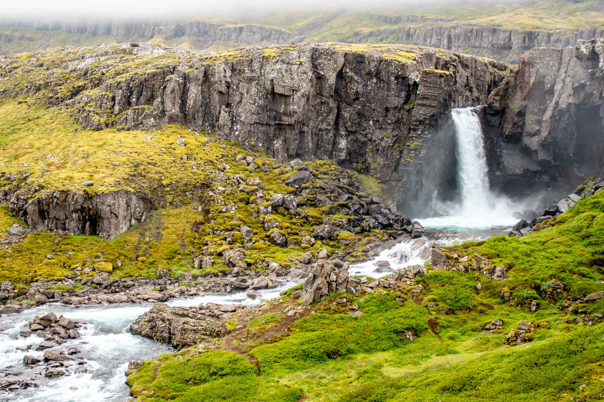 Rugged waterfall on a foggy day