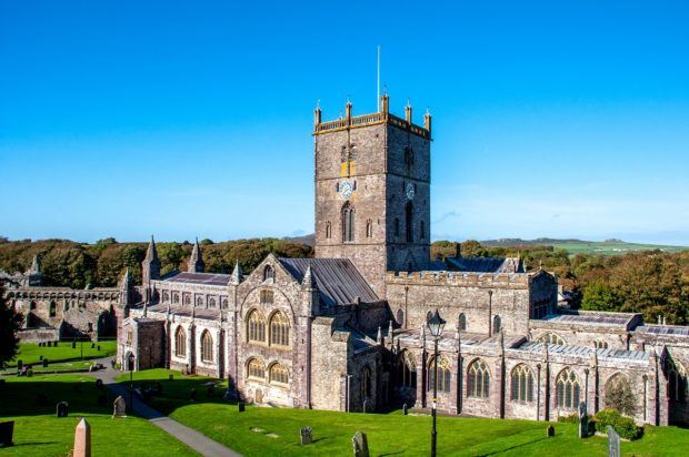 Stone cathedral surrounded by green grass