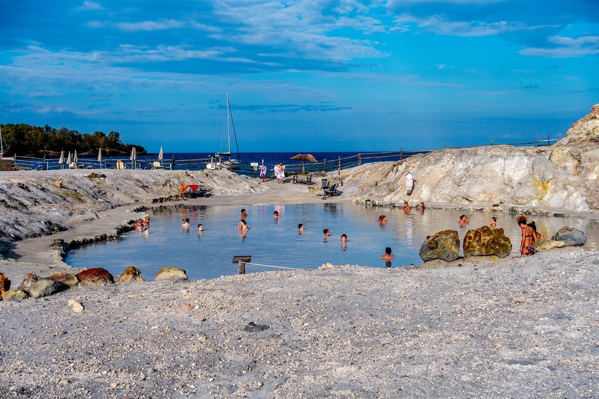 People soaking in the Vulcano Island mud baths in Italy.