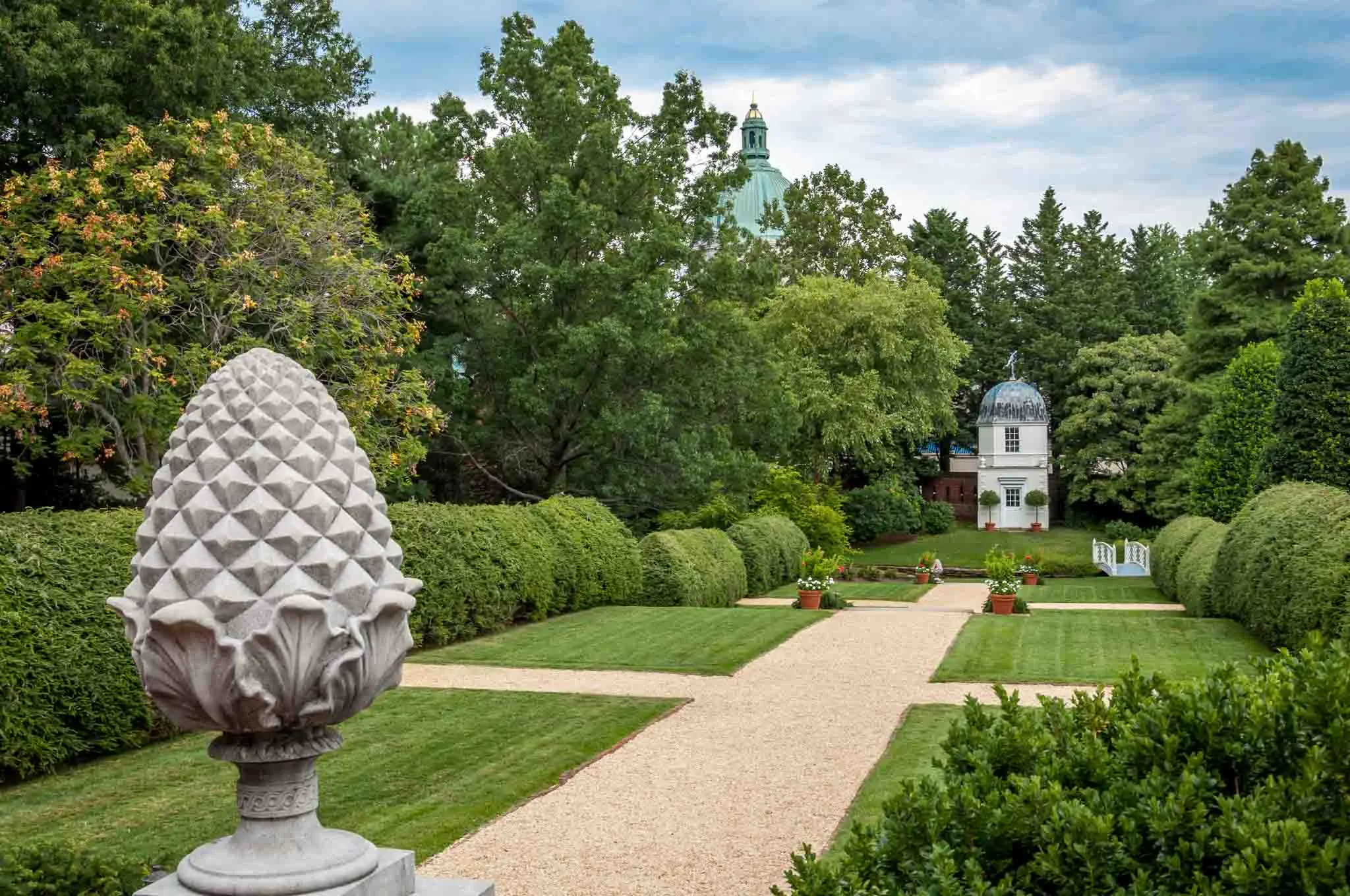 Tower and decorations in a lush, green garden.