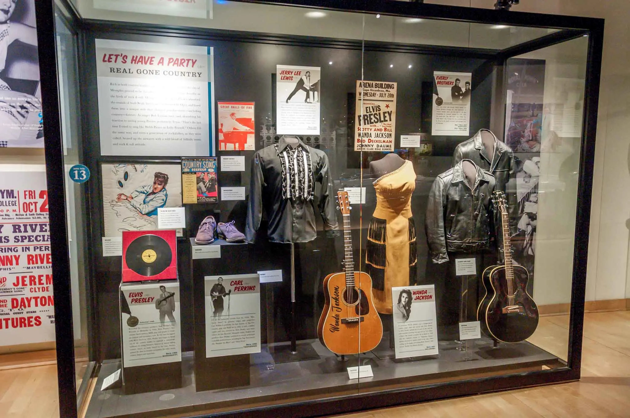 Museum display of records, guitars, and costumes.