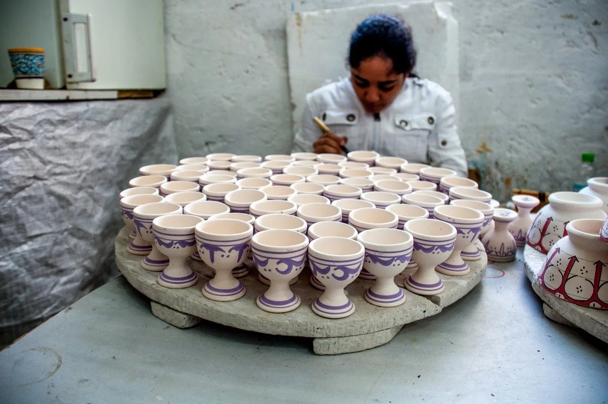 Girl painting pottery