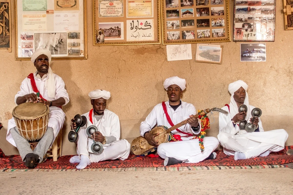 Seated Gnawa musicians performing