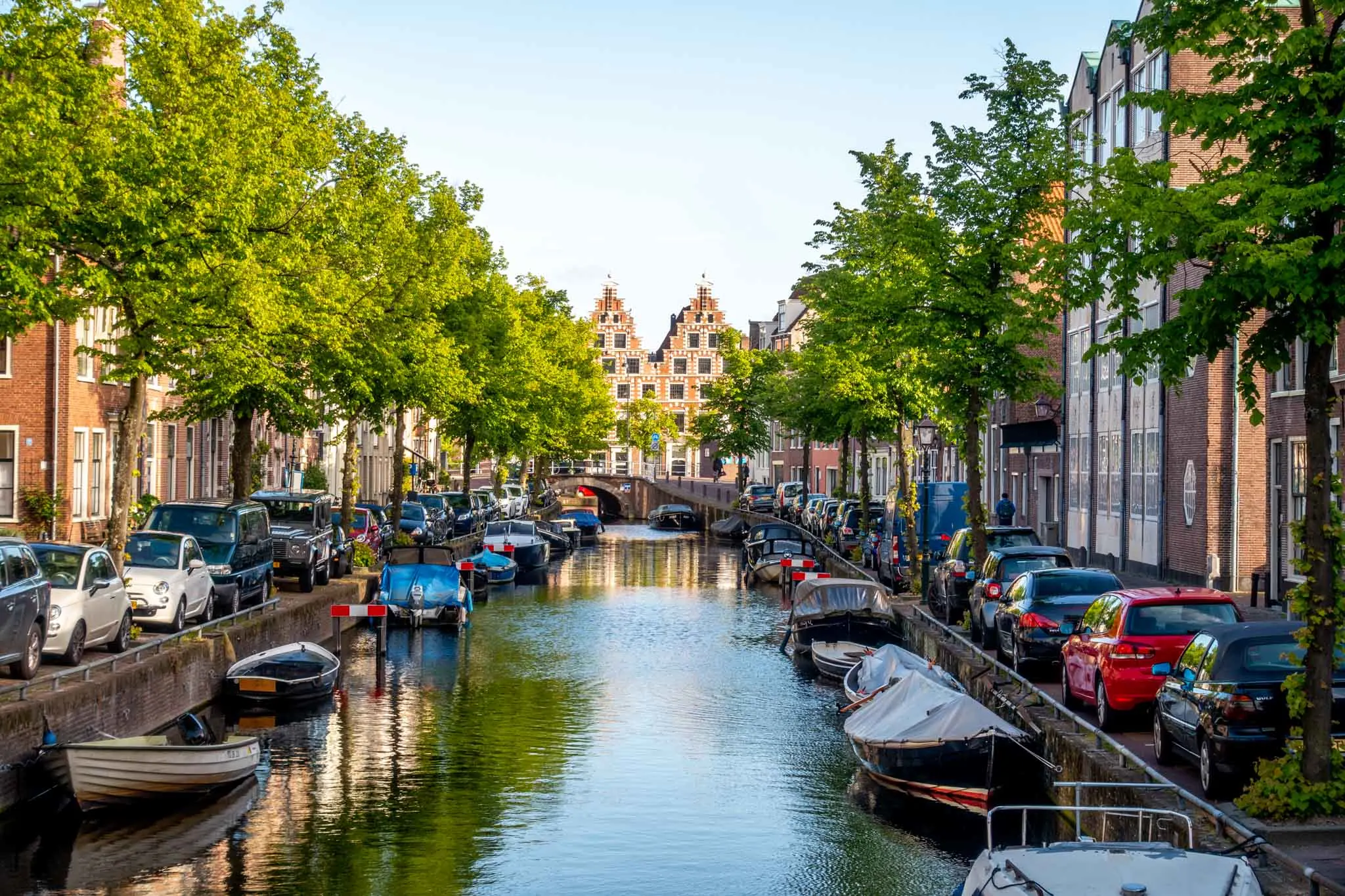 Boats and houses along a canal near sunset in Haarlem, Netherlands