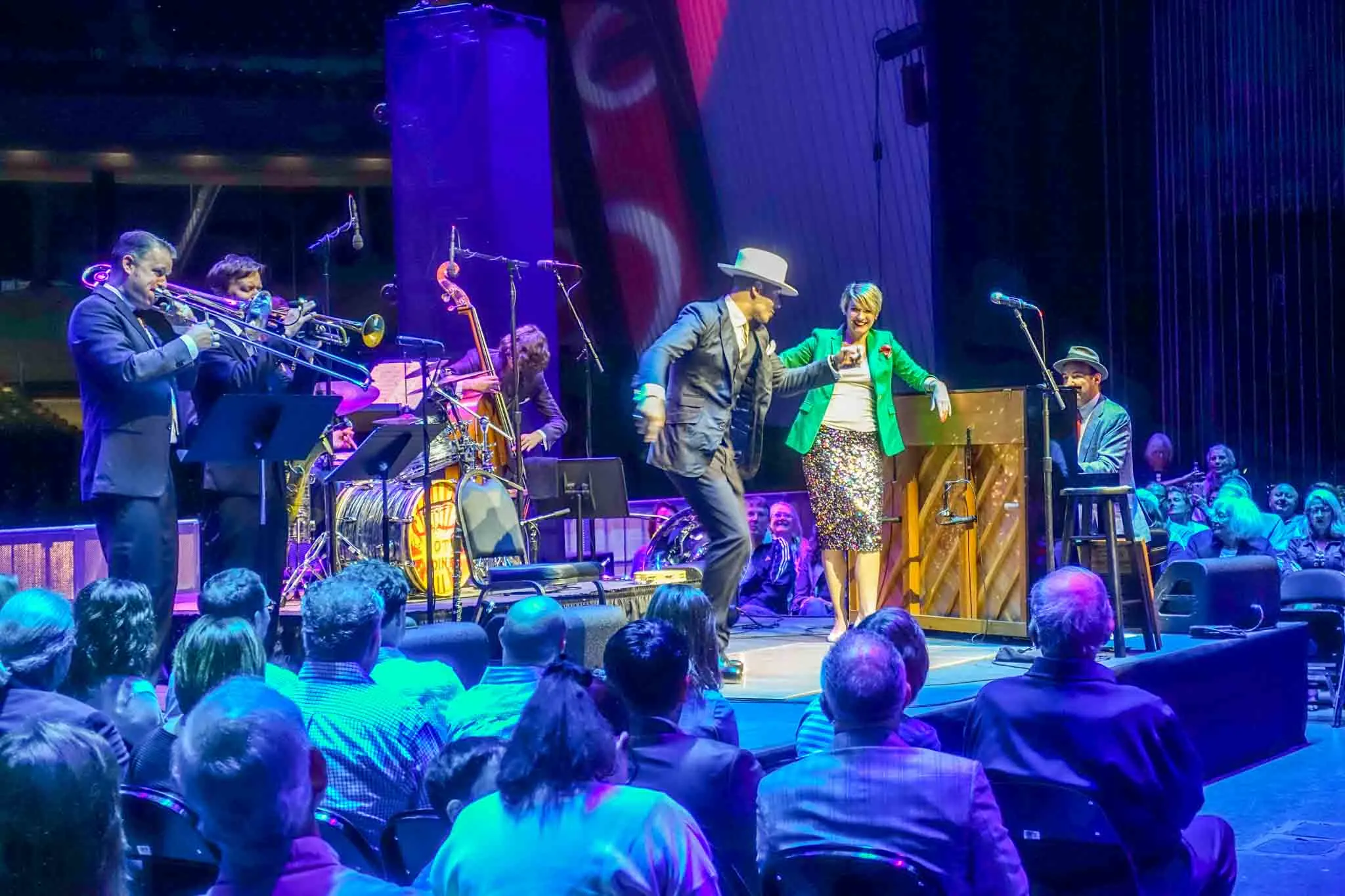 People dancing on stage with a band