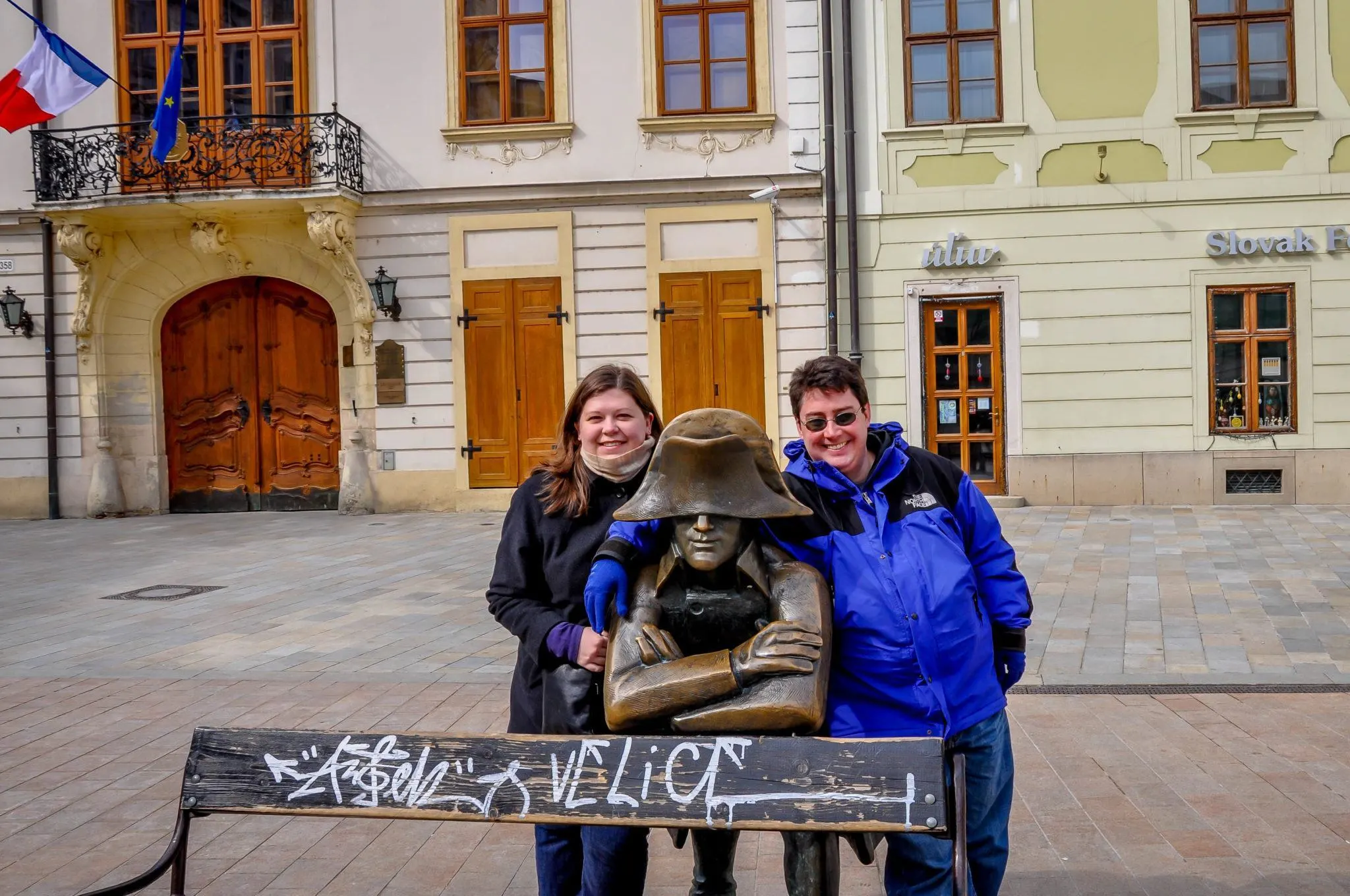 Laura and Lance posing with a statue of Napoleon.