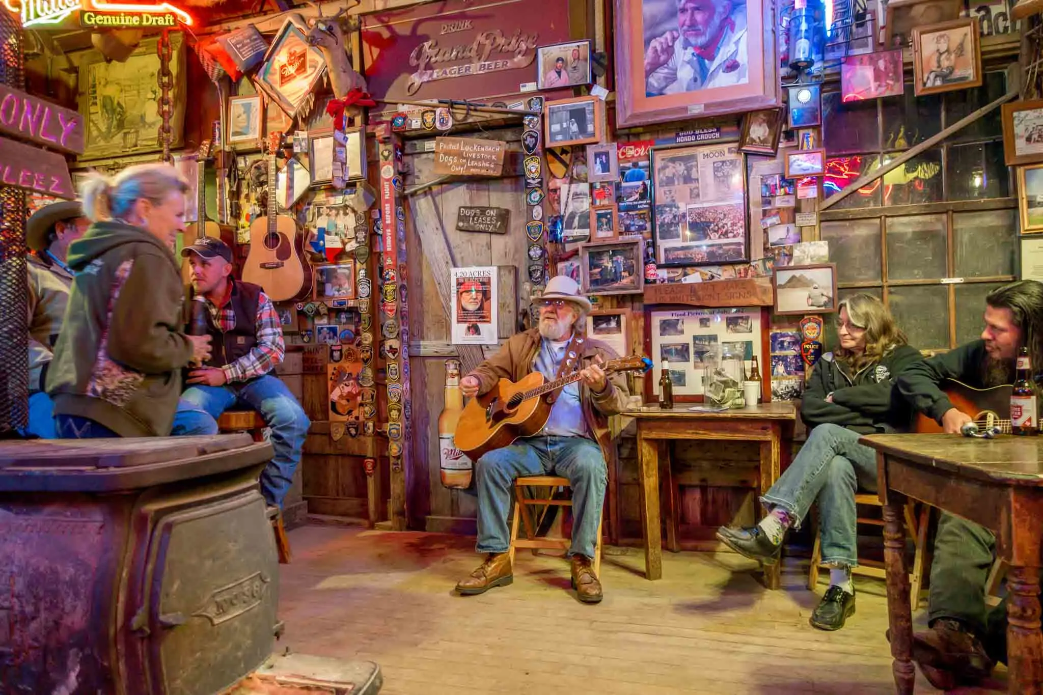 Guitar player and listeners in a cozy bar