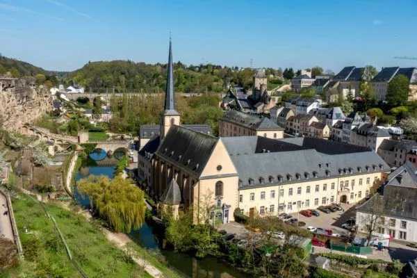 Church and other buildings beside a stream 