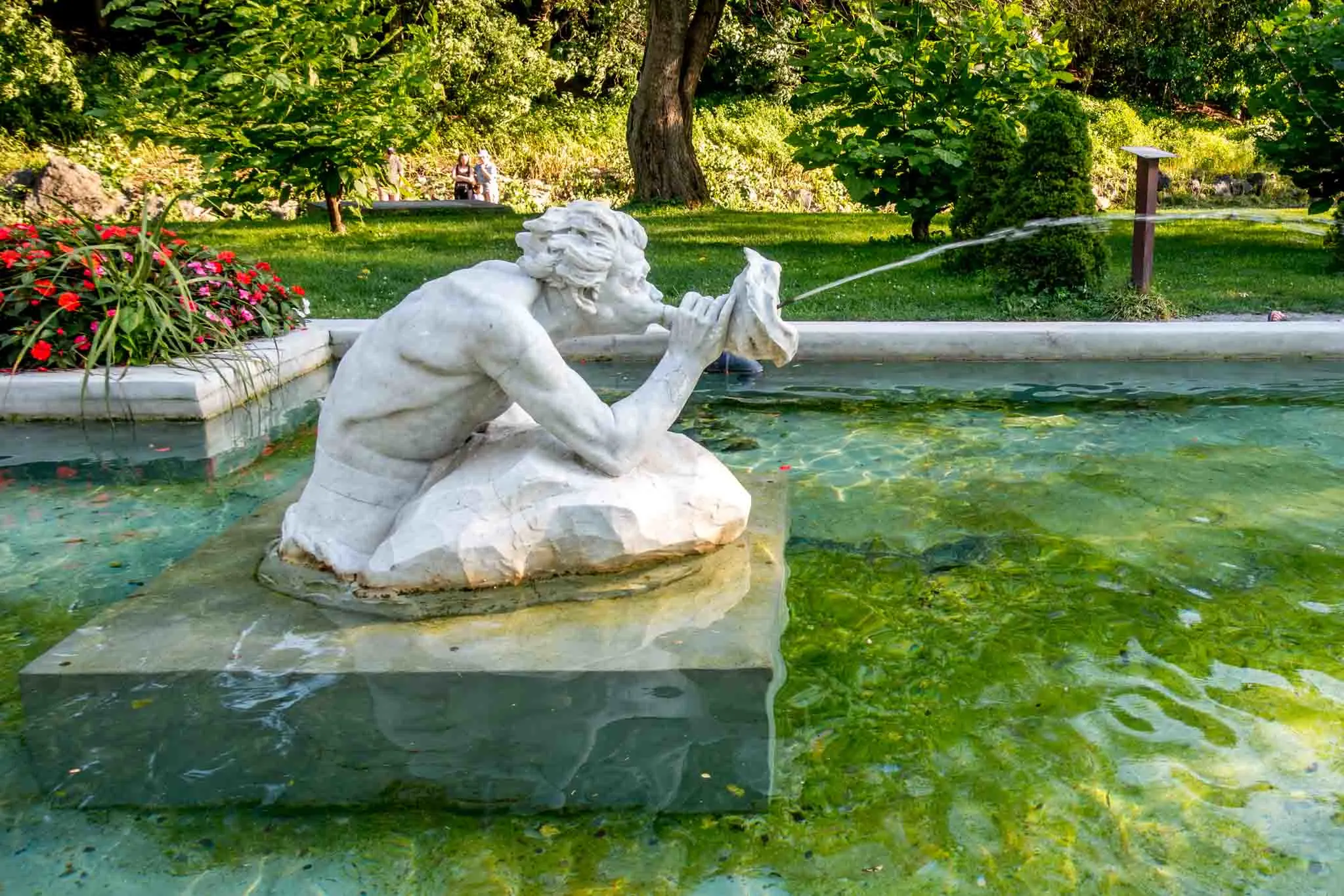 Mermen fountain spouting water 