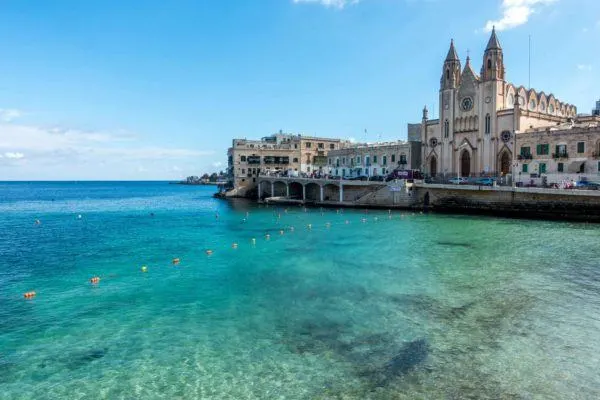 Church and buildings beside the ocean