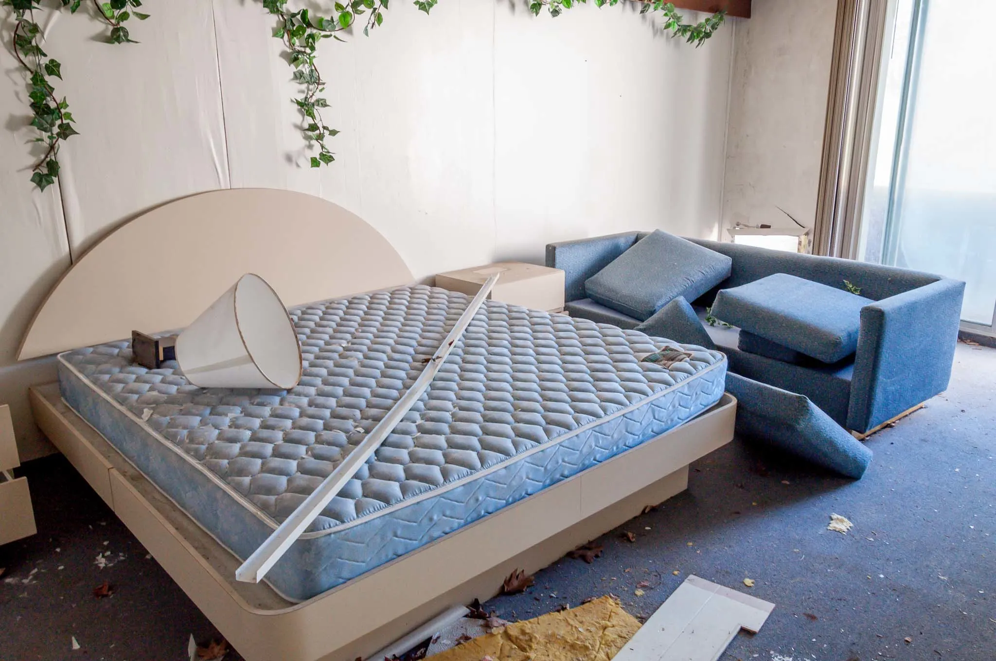 A bed and couch in one of the old hotels