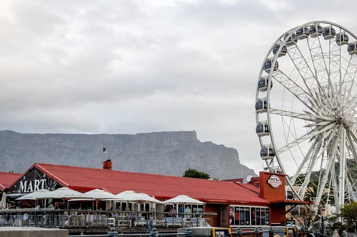 Ferris wheel and building with a mountain in the background